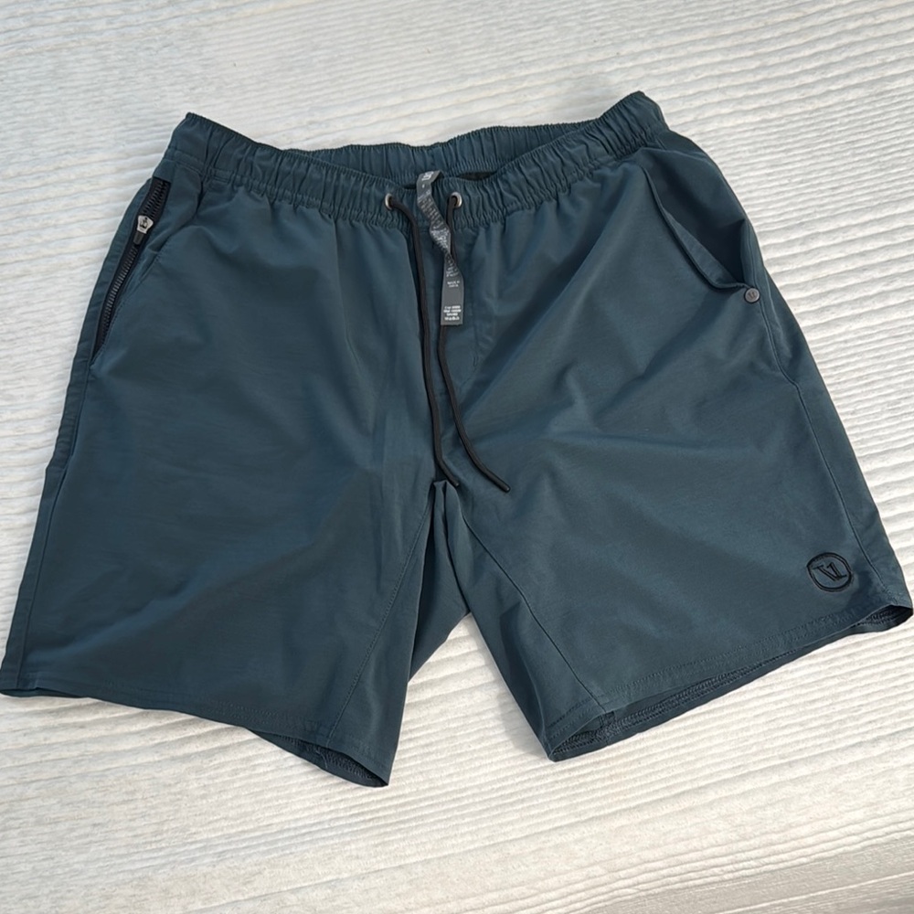 Men's Vuori Athletic Shorts.  Color is a dark blue green color.  Size S.